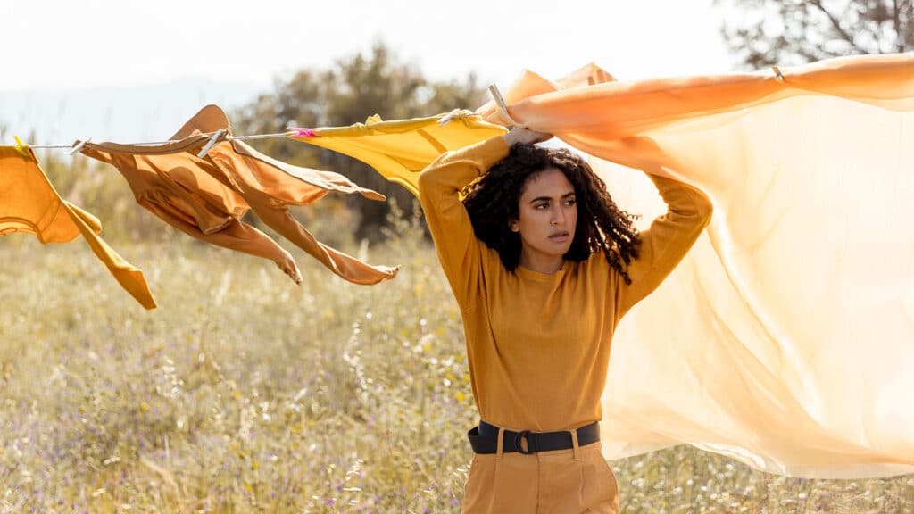 woman outside with washed clothes line