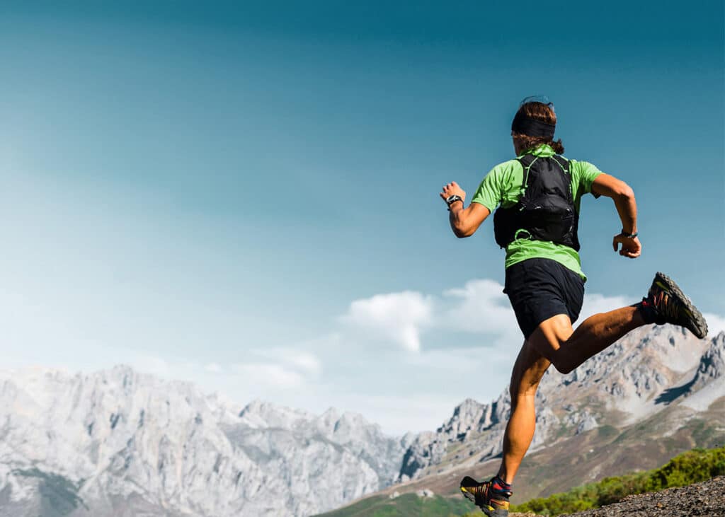 man running in the mountains in antimicrobial activewear 