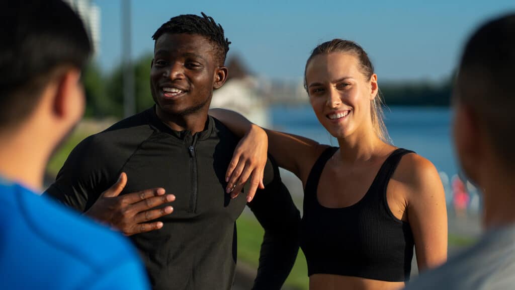man and woman wearing performance apparel